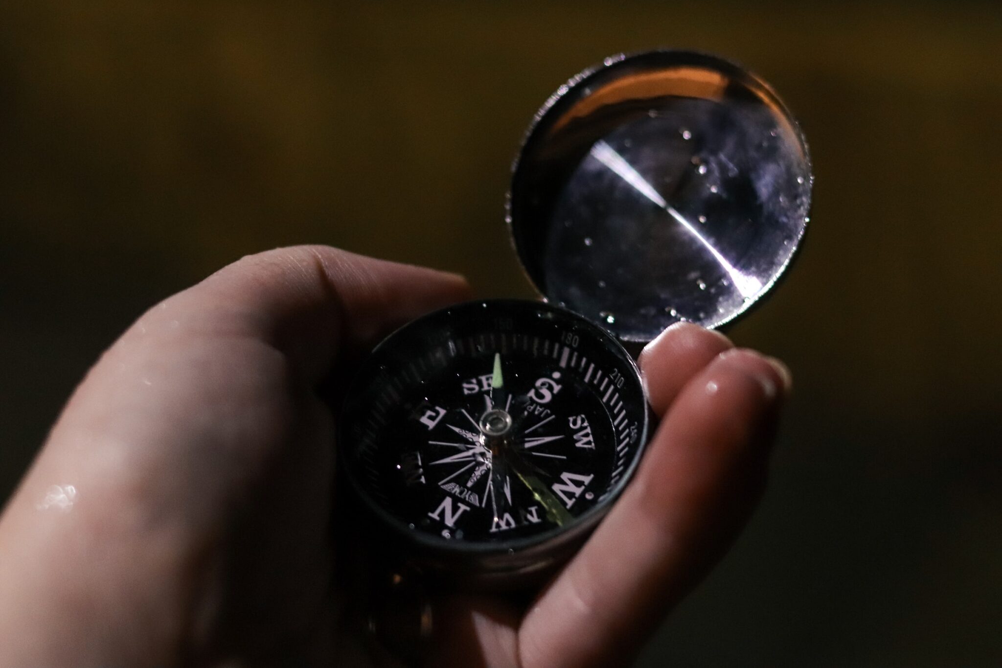 Closeup of hand holding compass.