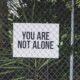 sign reminding readers "you are not alone"
